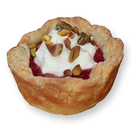 Cherry hand pie, with whip cream and pistachios